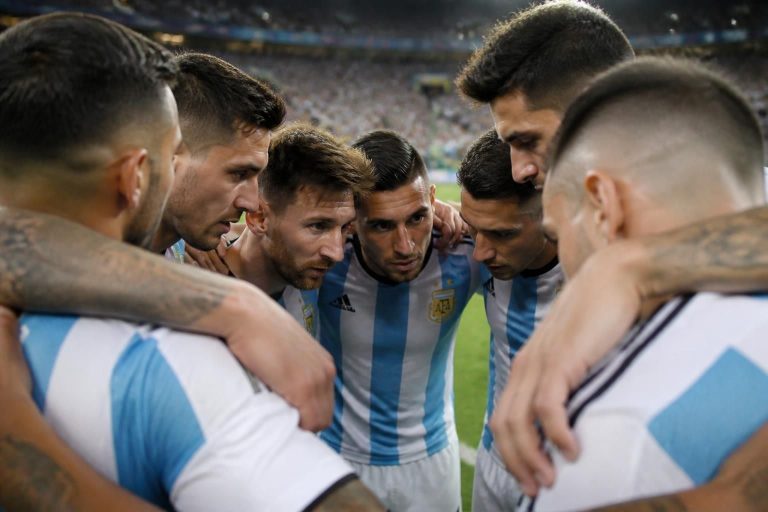 a heartfelt moment captured as argentine players unite with determination and spirit before their intense clash with algeria.